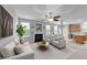 Bright living room with fireplace, ceiling fan, and open access to the kitchen, perfect for entertaining at 3705 Rivermist Dr, Raleigh, NC 27610