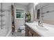 Well-lit bathroom with patterned floor, shower-tub combination, and a plant at 3803 Jonesville Rd, Wake Forest, NC 27587