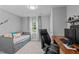 Cozy bedroom with daybed, storage drawers, desk, and natural light at 3803 Jonesville Rd, Wake Forest, NC 27587