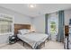 Bedroom with a wooden headboard, a bedside table, and blue curtains at 3803 Jonesville Rd, Wake Forest, NC 27587