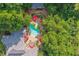 Scenic aerial shot of a backyard with a unique pool, patio, and mature tree coverage at 4021 Chaumont Dr, Apex, NC 27539