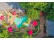 Gorgeous aerial view of backyard featuring a kidney-shaped pool, manicured landscape, and mature trees at 4021 Chaumont Dr, Apex, NC 27539