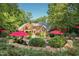 Expansive backyard featuring a pool, stone patio, lush landscaping, and mature trees at 4021 Chaumont Dr, Apex, NC 27539