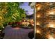 Beautiful backyard with an inviting pool and patio, enhanced by landscape lighting and mature trees at 4021 Chaumont Dr, Apex, NC 27539