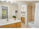 Bright bathroom features double sink vanity with mirror and shower tub with tile surround at 4021 Chaumont Dr, Apex, NC 27539