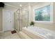 Elegant bathroom with a glass shower, jacuzzi tub, and stained glass window at 4021 Chaumont Dr, Apex, NC 27539
