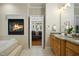 Luxurious bathroom with a fireplace, soaking tub, and double vanity at 4021 Chaumont Dr, Apex, NC 27539