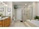 Bathroom with a glass shower, soaking tub, and double sink vanity at 4021 Chaumont Dr, Apex, NC 27539