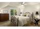 Charming bedroom featuring a ceiling fan and plenty of natural light, creating a comfortable and peaceful atmosphere at 4021 Chaumont Dr, Apex, NC 27539