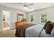 Inviting bedroom with soothing natural light, a wooden dresser, and an attached bathroom entrance at 4021 Chaumont Dr, Apex, NC 27539