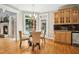 Bright breakfast nook with a glass table, hardwood floors, and a view of the backyard at 4021 Chaumont Dr, Apex, NC 27539