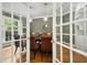 Elegant dining room with french doors, stylish chairs, and a modern light fixture at 4021 Chaumont Dr, Apex, NC 27539