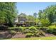 Beautiful exterior of a two-story brick home featuring a manicured front lawn and mature trees at 4021 Chaumont Dr, Apex, NC 27539