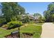Front view of brick home with a well-manicured front yard and long concrete driveway leading to the house at 4021 Chaumont Dr, Apex, NC 27539