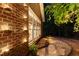 Exterior shot of a brick home with a side yard featuring low-voltage landscaping lights at 4021 Chaumont Dr, Apex, NC 27539