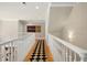 Spacious hallway with a decorative runner, offering a stylish transition between different parts of the home at 4021 Chaumont Dr, Apex, NC 27539