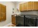 Well-equipped laundry room with modern appliances and ample storage space, adding convenience to daily chores at 4021 Chaumont Dr, Apex, NC 27539