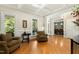 Bright living room with hardwood floors, large windows, and classic trim details at 4021 Chaumont Dr, Apex, NC 27539