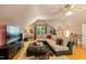 Spacious living room featuring hardwood floors, entertainment center, sectional seating, and game table at 4021 Chaumont Dr, Apex, NC 27539