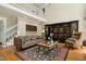 Comfortable living room featuring a sofa, bookshelves, and a view of the second-floor balcony at 4021 Chaumont Dr, Apex, NC 27539