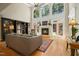 Spacious living room with high ceilings, a fireplace, and large windows overlooking the yard at 4021 Chaumont Dr, Apex, NC 27539