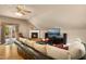Inviting living room with fireplace, hardwood floors, a large screen TV, and comfortable seating at 4021 Chaumont Dr, Apex, NC 27539