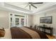 Main bedroom with French doors to the pool, a ceiling fan, and an en-suite bathroom at 4021 Chaumont Dr, Apex, NC 27539