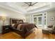 Relaxing main bedroom with a king bed, ceiling fan, and French doors to the pool at 4021 Chaumont Dr, Apex, NC 27539