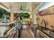 Entertainer's outdoor kitchen with stainless steel appliances, granite counters, and covered patio space at 4021 Chaumont Dr, Apex, NC 27539