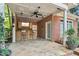 Covered patio bar with outdoor ceiling fan, television, and ample seating for entertaining guests at 4021 Chaumont Dr, Apex, NC 27539