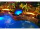 Aerial view of a stunning pool with waterfalls, fire features, mature landscaping, and stone accents at 4021 Chaumont Dr, Apex, NC 27539