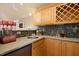 Functional wet bar with granite countertops, custom cabinets, wine rack, and mosaic tile backsplash at 4021 Chaumont Dr, Apex, NC 27539
