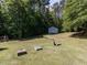 Large backyard with shed surrounded by lush trees at 4132 Battle Field Dr, Garner, NC 27529