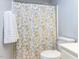 Bathroom with a white floral shower curtain, toilet and towel at 4132 Battle Field Dr, Garner, NC 27529
