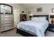This bedroom features a dresser with a large mirror, a bookshelf, and a plush bed with decorative pillows at 4132 Battle Field Dr, Garner, NC 27529