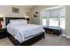 Cozy bedroom with a bay window features a large bed, neutral walls, and carpeted floors at 4132 Battle Field Dr, Garner, NC 27529