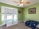 Bedroom with bay window, ceiling fan, and play area at 4132 Battle Field Dr, Garner, NC 27529
