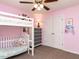 Pink bedroom featuring bunk beds, ceiling fan, and closet at 4132 Battle Field Dr, Garner, NC 27529