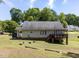 Exterior view of home with deck and well-maintained lawn at 4132 Battle Field Dr, Garner, NC 27529