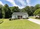 Charming home with a well-manicured lawn, complemented by mature trees and a driveway at 4132 Battle Field Dr, Garner, NC 27529