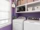 Laundry room includes washer and dryer, built in shelving and storage, and a window for natural light at 4132 Battle Field Dr, Garner, NC 27529