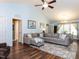 Bright living room featuring vaulted ceilings, hardwood floors, and a comfortable gray sectional sofa at 4132 Battle Field Dr, Garner, NC 27529