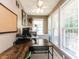 Well-lit home office features a large wooden desk, neutral walls, and two large windows with white blinds at 4132 Battle Field Dr, Garner, NC 27529