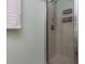 Glass enclosed shower with chrome shower head and towel hook for added convenience at 4132 Battle Field Dr, Garner, NC 27529