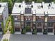 Aerial view of townhomes with balconies, garages, and modern architectural design in a vibrant urban setting at 414 Chavis Way, Raleigh, NC 27601