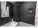 Contemporary bathroom featuring sleek gray tiling, shower with caddy, and modern fixtures at 414 Chavis Way, Raleigh, NC 27601