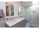 Elegant bathroom featuring double sinks, quartz countertops, stylish lighting, and a frameless glass shower at 414 Chavis Way, Raleigh, NC 27601