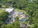 An aerial perspective shows the community park's splash pad, playground, and green spaces, perfect for Gathering enjoyment at 414 Chavis Way, Raleigh, NC 27601