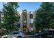 Modern townhome with gray siding, black framed windows, and brick accents, surrounded by lush trees at 414 Chavis Way, Raleigh, NC 27601
