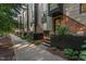 Modern townhome exterior featuring a mix of brick and metal siding, plus attractive planters at 414 Chavis Way, Raleigh, NC 27601